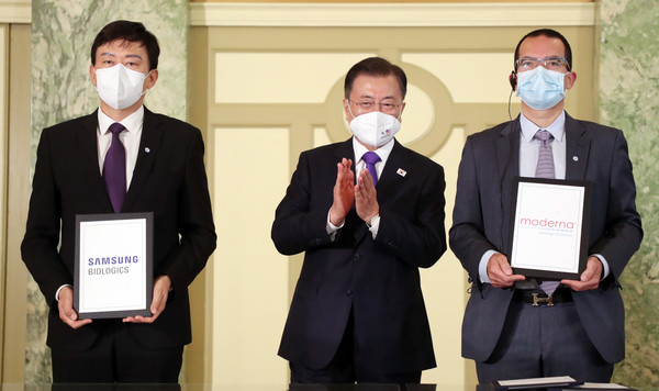 문재인 대통령이 22일 오전(현지시간) 미국 워싱턴 시내 한 호텔에서 열린 '한미백신기업 파트너십 행사'에 참석해 삼성바이오로직스와 모더나 간의 위탁 생산 계약 MOU 체결에 박수를 보내고 있다. 왼쪽부터 존림 삼성바이오로직스 사장, 문 대통령, 스테판 반셀 모더나CEO. 2021.05.22 / 사진=[뉴시스]