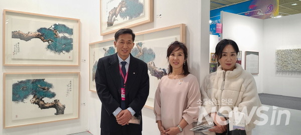 한국미술협회 회원들이 고재봉 작가 부스를 찾아 기념촬영을 하고 있다(사진=정경호 기자)