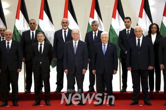 ▲3월 31일 서안지구 라말라에서 마무드 아바스 팔레스타인 자치정부 수반(앞줄 오른쪽 두 번째)과 무함마드 무스타파 신임 총리(가운데)가 신임 내각 각료들과 기념 촬영을 하고 있다. (사진=신화통신)