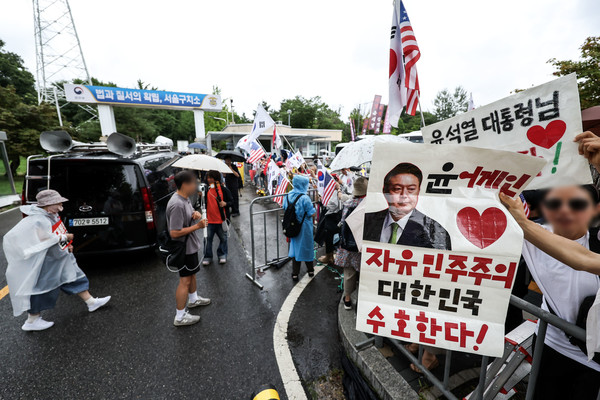 내란 특검 소환에 불응한 윤석열 전 대통령에 대한 강제 구인 절차에 돌입한 15일 오후 경기 의왕시 서울구치소 앞에서 윤 전 대통령 지지자들이 태극기와 성조기를 들고 있다. 2025.07.15.